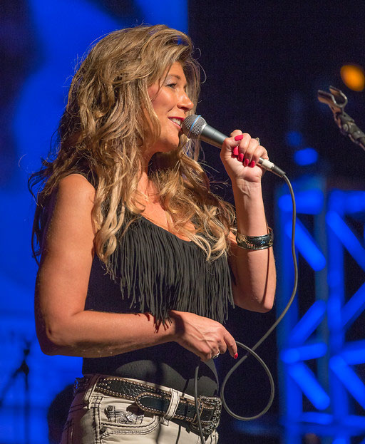 Female vocalist in black fringed top
