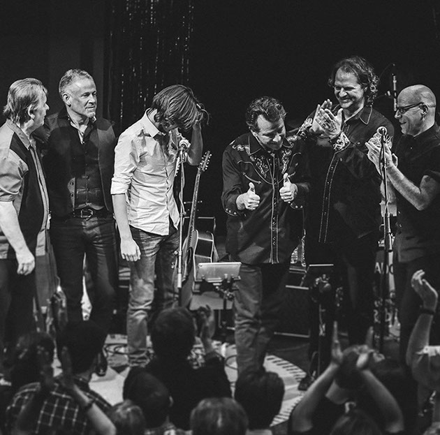Six men performing on stage