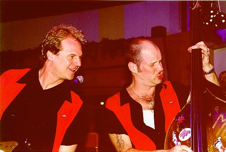 Two men in red and black jackets at venue