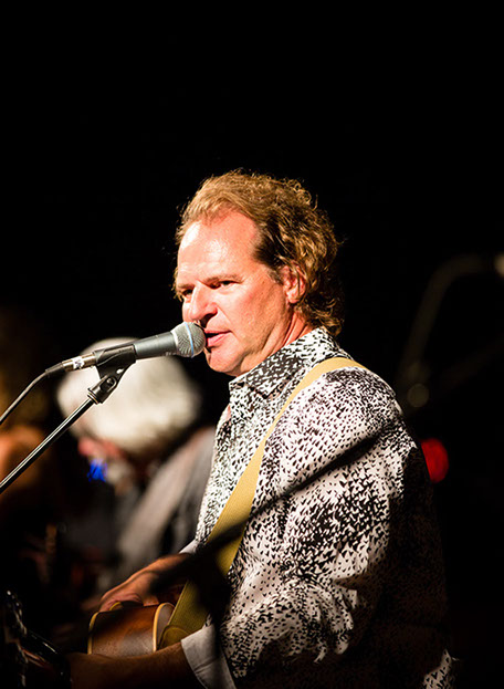 Matt Vee singing in patterned jacket
